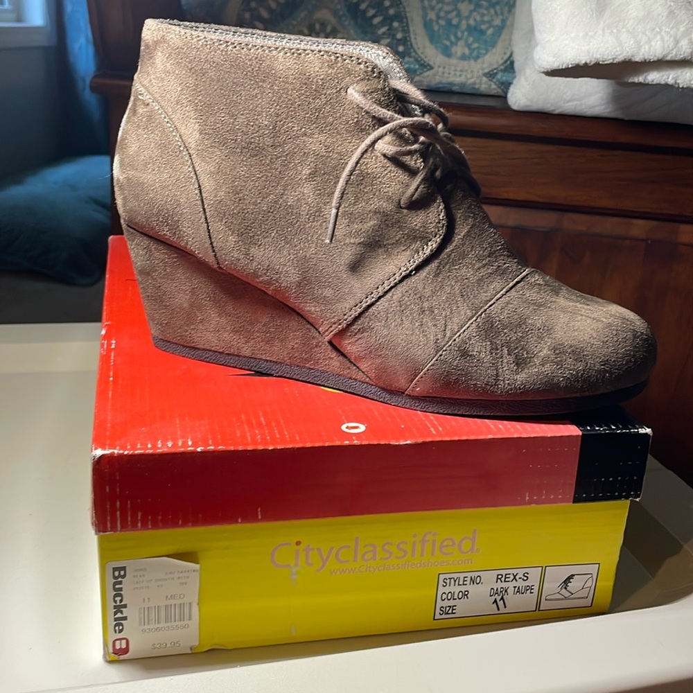 Brown lace up boots that are like the TOMS wedge booties.